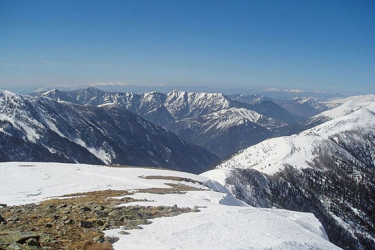 Depuis la cime du Pisset, (2233 m), au fond au milieu de la ligne de crête enneigée, le Caïre Gros, (2087 m).