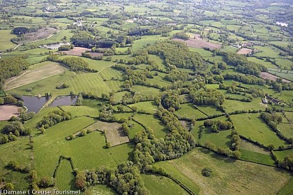 Panoramic view of the farmland crisscrossed by hedges and trees