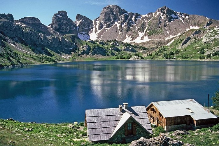 Le lac d'Allos, (2228 m), le refuge des bords du lac, en fond, les Tours du Lac, en début d'été