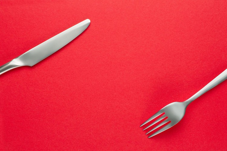 Fork and knife on red background