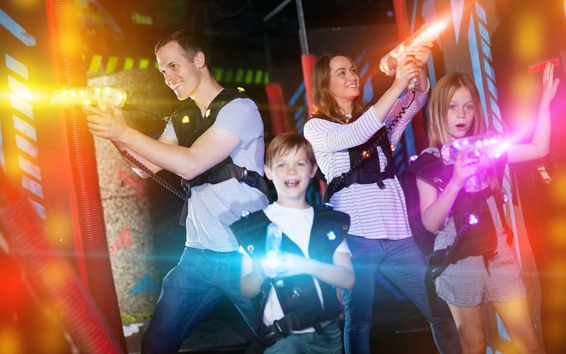 Kids and parents in beams during laser tag game
