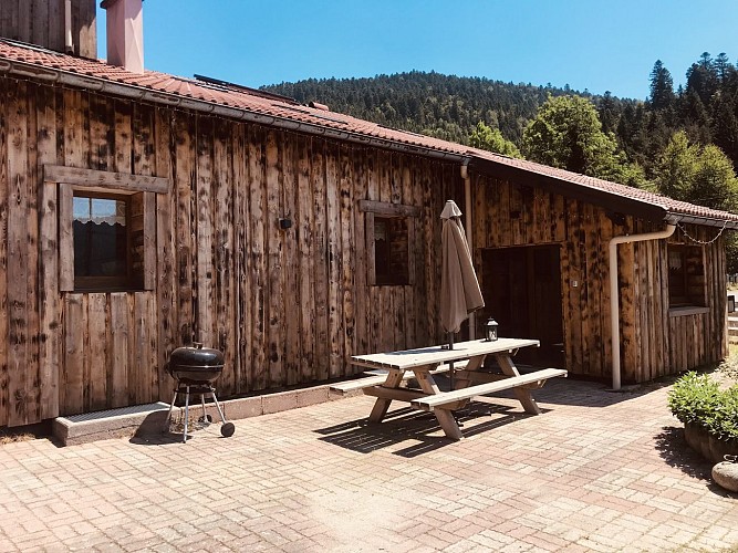 Entrée du gîte, terrasse avec espace pique-nique, barbecue charbon de bois (non fourni).