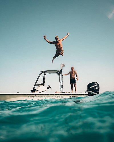photo-of-man-jumping-from-boat-to-the-sea-1122462